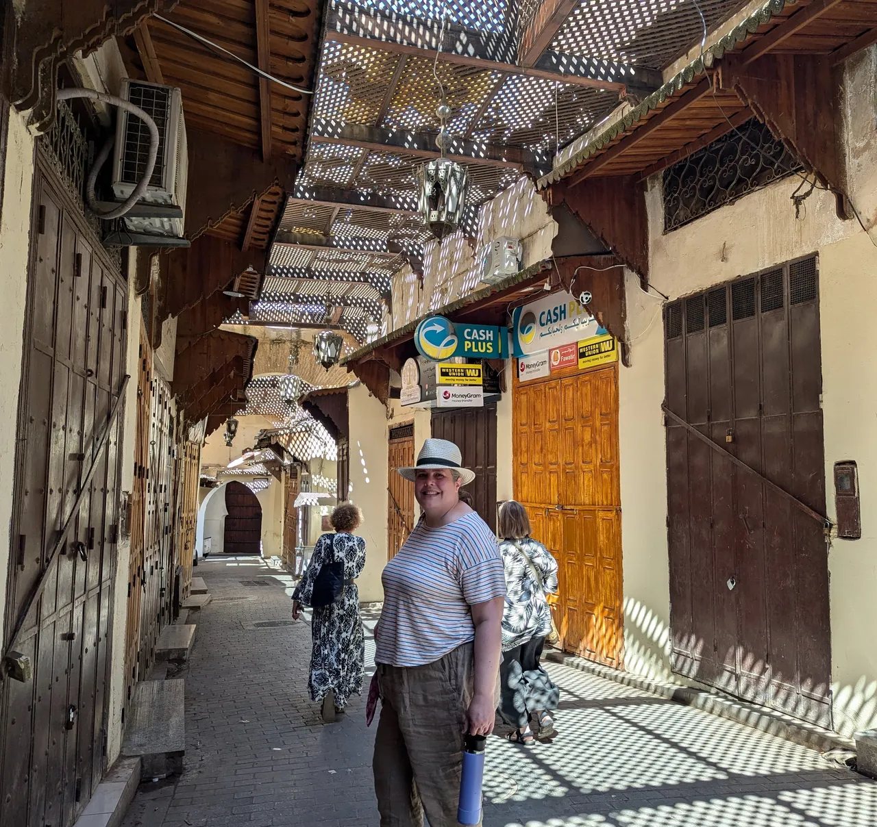 Chrissy in the nearly empty medina. Normally these doors would all be open, each a shop selling their wares.