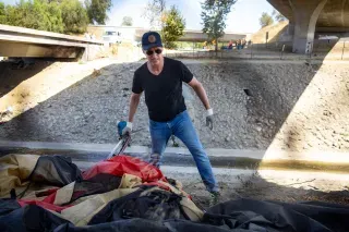 He did not need to participate in this and pose alongside it. You just know he loves this as much as he seems to hate the homeless.