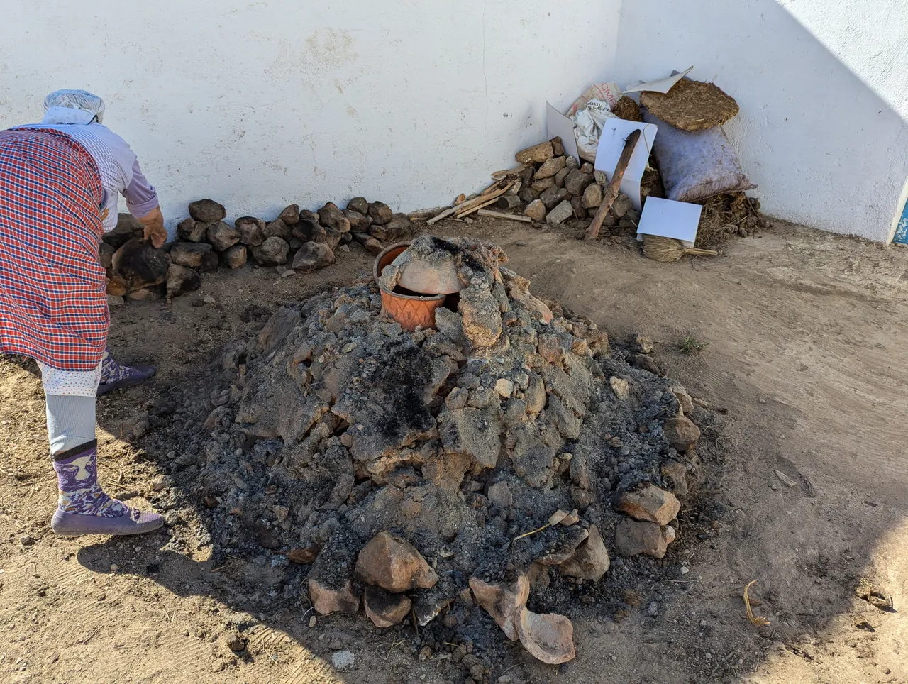 Mama Aicha unpacking the rocks and ashes