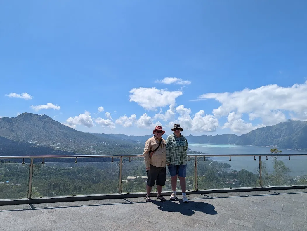 The ussie of the day. You can see the rim wall of the original (very large) caldera. There are other newer volcanoes inside. The lake is the highest-elevation lake in Bali; all rice farming happens at lower altitudes due to irrigation constraints. Up above, they grow other stuff, like coffee. In the back of the lake you can see the lighter water. This is a sulfur bloom, it will triple in size while we watch it.