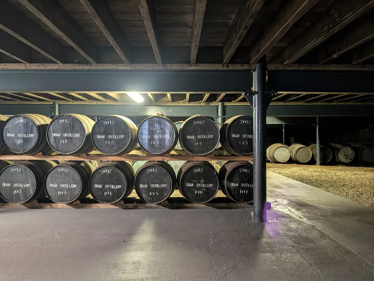White oak bourbon barrels in front, the back-right is red oak sherry barrels. The sherry barrels are twice as big. Typical barrels are used about four times, between each time they get disassembled, the top layer is sanded off, then they toast and scorch the inside before putting more whiskey in. At 14 years per batch, that puts each barrel at 50 years or so of working lifetime.
