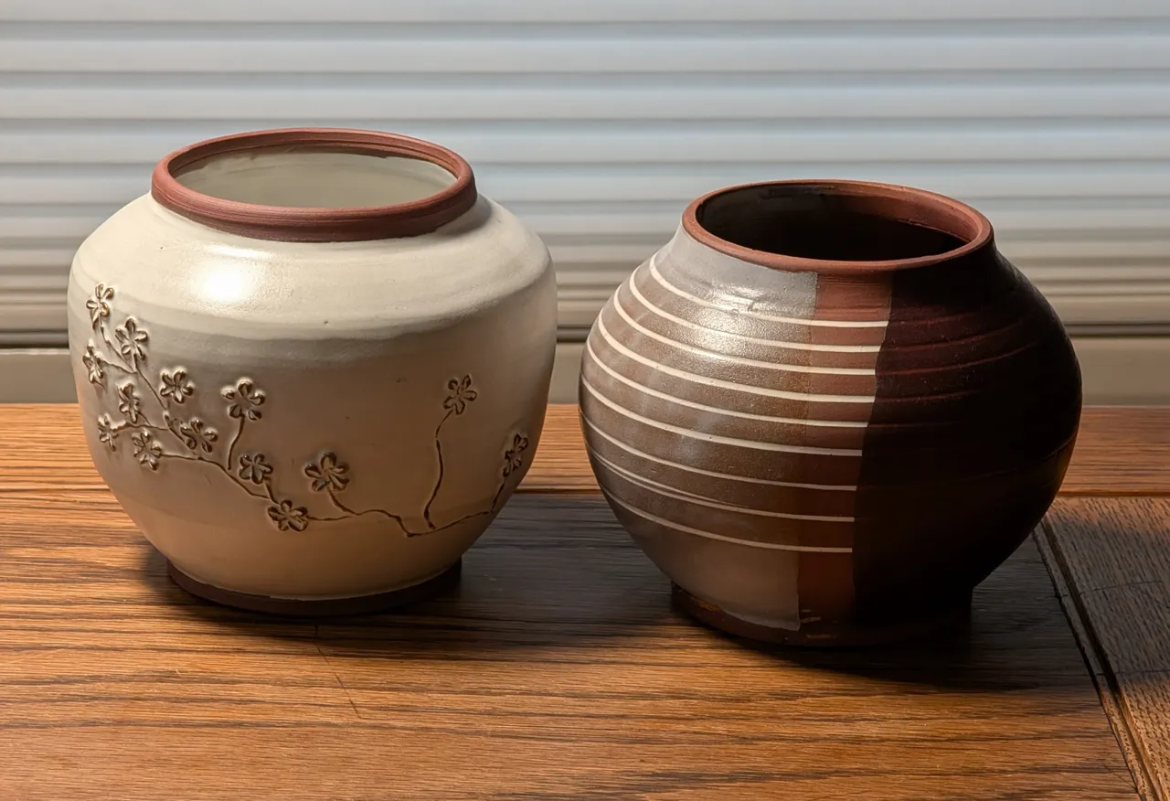 I really like doing team-ups with Chrissy. I threw these two bodies, and then she decorated the one on the left (adding slip to the still-wet object in the form of the flowers) and I did the one on the right (slicing out a gouge in the wet clay, filling it back in with porcelain slip, and then trimming it back to mostly flat (ish)).