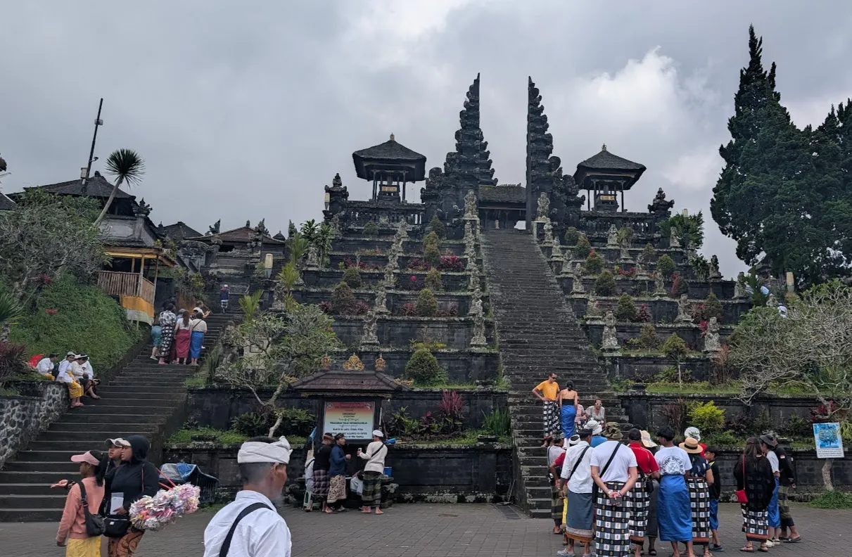 Close to the base of the main stairs, tourists wait to have their photo taken on the sacred central stairs.