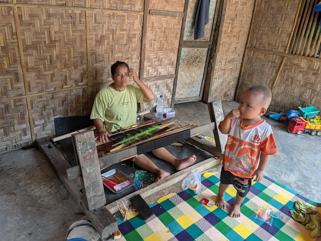 Another weaver. Her kid spent most of the time watching some streaming videos that were in english; “let’s learn the names of Fruit!” it would sing-song, then “banana, pineapple, star-fruit!” in the chorus. That type of thing.