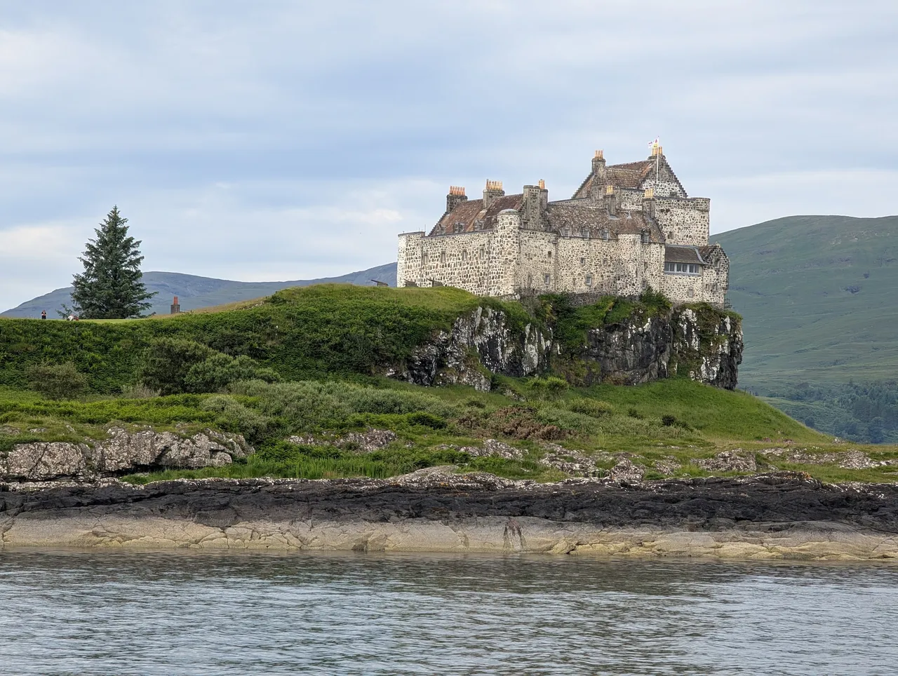Castle Duart on the Island of Mull. Built in the 1300s, it’s still inhabited. The flag is supposed to indicate that the Laird is in residence, so actually inhabited.