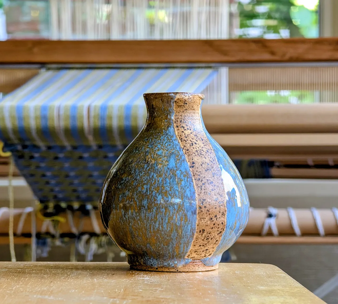 This is a speckled clay body, which I masked (the stripes) and dipped into a blue glaze. Then I removed the mask and poured a yellow/orange glaze over the whole thing (you should not dip an already-glazed object into another color, it will ruin the other color if there’s a bad interaction). I love the golden streaks and the way the underlying clay comes through.