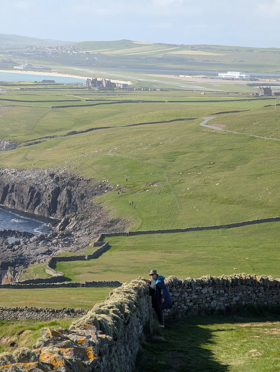 There were times when I felt like I could just reach out and step into the landscape, like falling into a painting or a dream. Here we see Chrissy watching the puffins, plus much further out, the rest of our tour group walking along the coast to meet up with us. We took a shortcut.