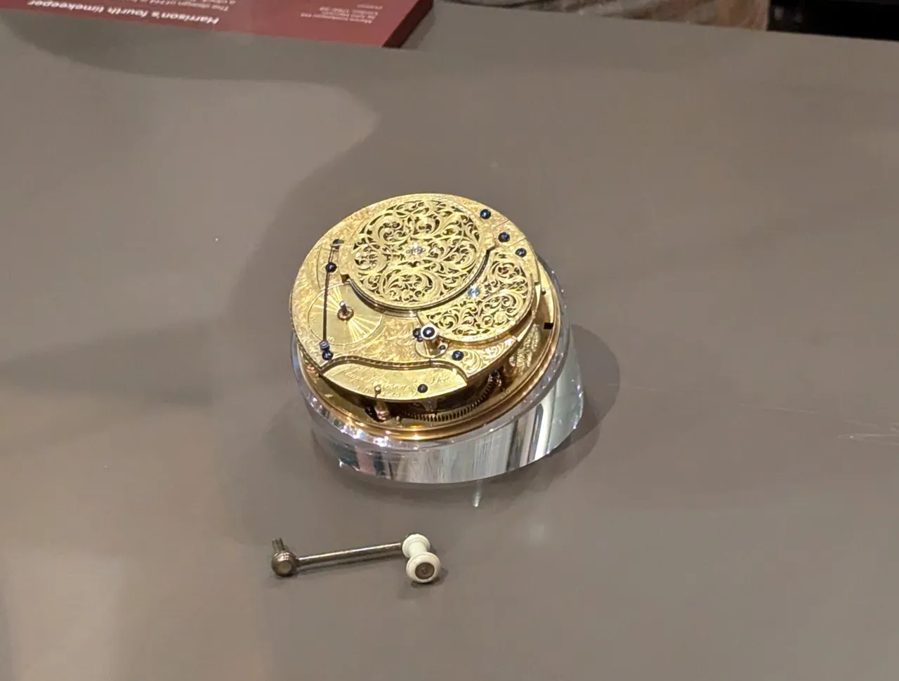 Here’s the H4. It is tiny in comparison. We have the flat spinning weight, and a way to be able to crank the mainspring without stopping the clock (critical if it needs to be wound every day).